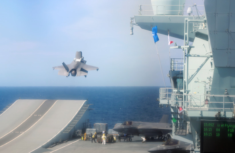 An F-35B Lightning II aircraft takes off from the HMS Queen Elizabeth aircraft carrier offshore Portugal, May 27, 2021. (photo credit: REUTERS/BART BIESEMANS)