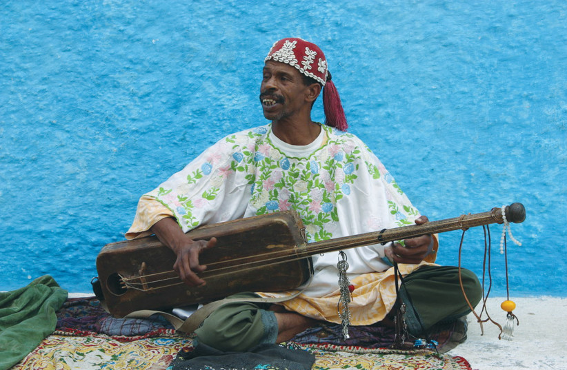  A Gimbri playing in Rabat, Morocco (photo credit: Wikimedia Commons)