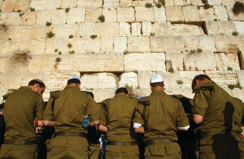  ISRAELI SOLDIERS pray at the Western Wall. Will they continue serving for such little pay? (credit: OLIVIER FITOUSSI/FLASH90)