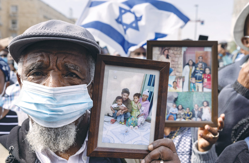  RELATIVES HOLD photos of loved ones left behind in Ethiopia, at a protest outside the Prime Minister’s Office in Jerusalem last week demanding that the government bring the rest of Ethiopia’s Jews to Israel. (photo credit: YONATAN SINDEL/FLASH90)