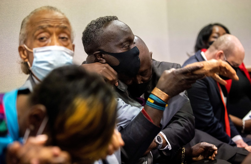 Ahmaud Arbery's father, Marcus Arbery, is hugged by his attorney Benjamin Crump after the jury convicted Travis McMichael in the Glynn County Courthouse, in Brunswick, Georgia, U.S., November 24, 2021. (credit: STEPHEN B. MORTON/POOL via REUTERS)