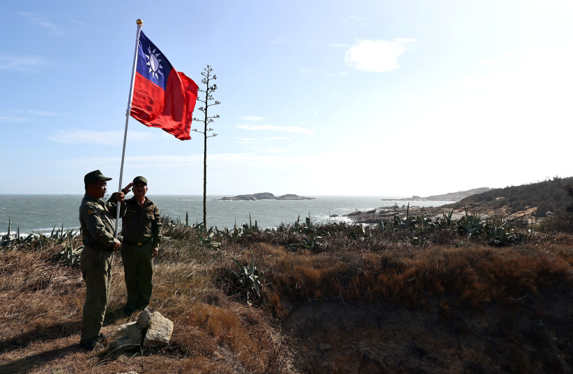  Veterans take part in a flag raising ceremony at a former military post on Kinmen, Taiwan, October 15, 2021. Sitting on the front line between Taiwan and China, Kinmen is the last place where the two engaged in major fighting, in 1958 at the height of the Cold War. (credit: REUTERS/ANN WANG)