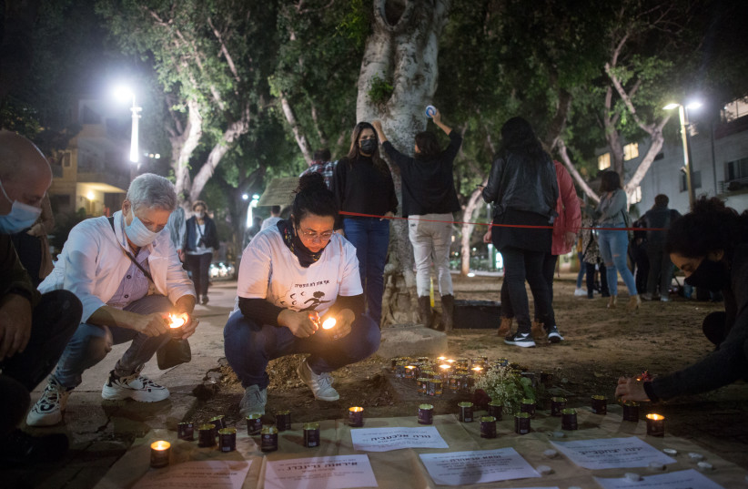  Israelis light candles in memory of women murdered in domestic violence, at a set up memorial on Rothschild Boulevard, ahead of International Day of Violence Against Women. November 24, 2020.  (photo credit: MIRIAM ALSTER/FLASH90)