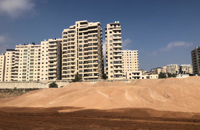  The site of the Atarot project, next to the security barrier and the apartments of Kafr Akab. (credit: TOVAH LAZAROFF)