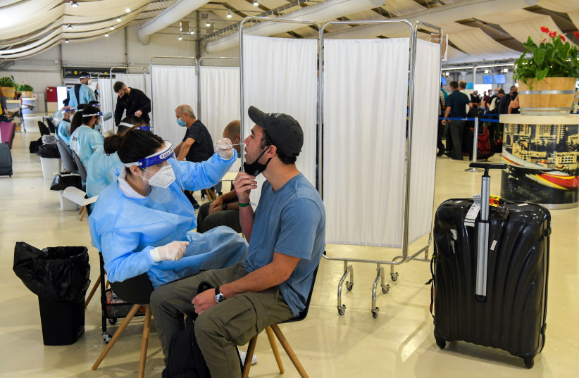  Medical technicians test passengers for COVID-19 at the Ben Gurion International Airport near Tel Aviv on March 8, 2021.  (credit: FLASH90)