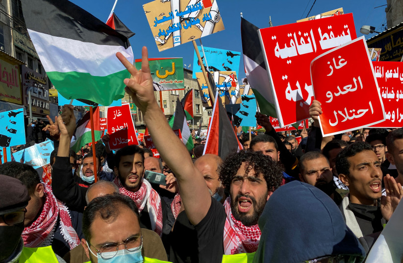  Jordanians carry flags and placards as they demonstrate against the declaration of intent for water-for-energy deal signed by Israel, Jordan and the UAE, in Amman, Jordan. (photo credit: MUATH FREIJ/REUTERS)