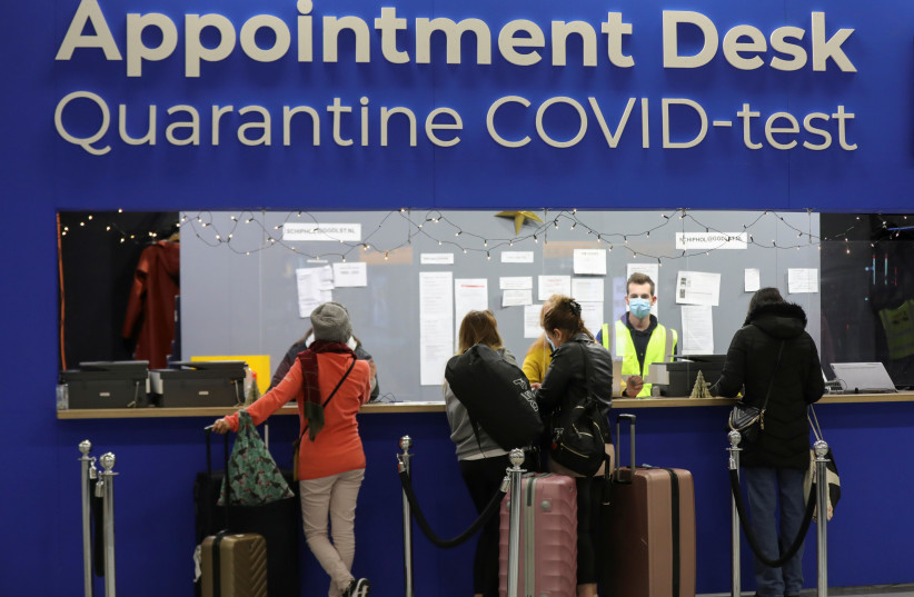  People wait in front of an ''Appointment Desk'' for quarantine and coronavirus disease (COVID-19) test appointments inside Schiphol Airport, after Dutch health authorities said that 61 people who arrived in Amsterdam on flights from South Africa tested positive for COVID-19, in Amsterdam, Netherlands (credit: REUTERS/EVA PLEVIER)