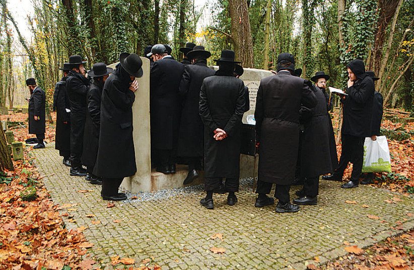  DESCENDANTS OF the Rabbi of Pilz Pinchas Menachem Elazar Justman, gather around his grave at the Jewish cemetery in Czestochowa, Poland. (photo credit: Asia Sidorowicz)