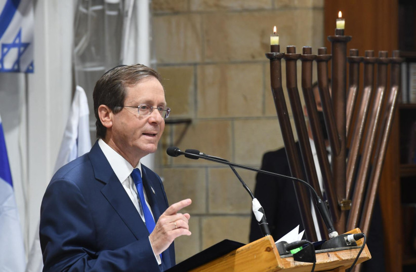 President Isaac Herzog speaks on the first night of Hanukkah at the Cave of the Patriarchs in Hebron, November 28, 2021. (photo credit: KOBI GIDEON/GPO)
