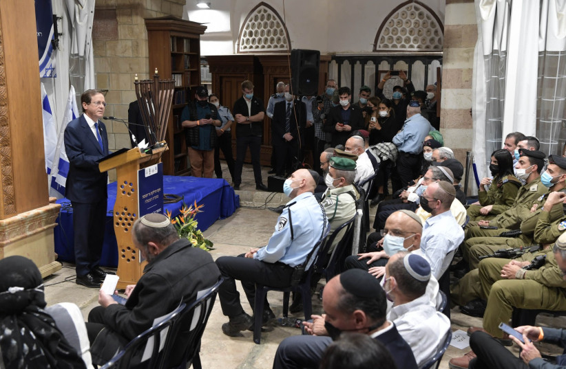 President Isaac Herzog speaks on the first night of Hanukkah in Hebron, November 28, 2021. (credit: KOBI GIDEON/GPO)
