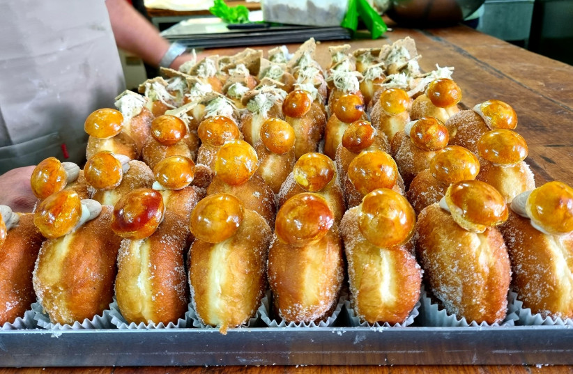  Two of the popular donuts created especially for Hanukkah this year. In the foreground are 'The Bride of Istanbul' and in the background are 'Old City' donuts. (photo credit: MAYA MARGIT/THE MEDIA LINE)