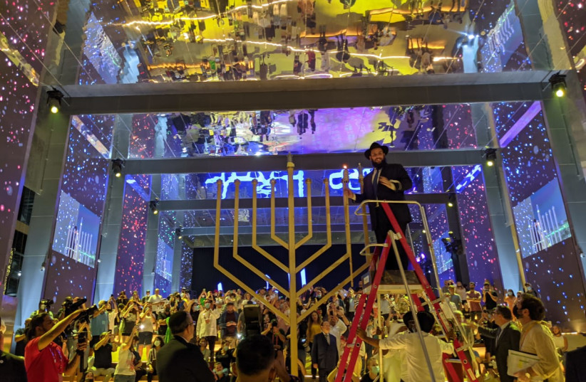  Rabbi Levi Duchman lights the Menorah at Dubai Expo 2020. (credit: Courtesy JEWISH UAE)