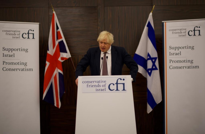   UK Prime Minister Boris Johnson speaking during a Conservative Friends of Israel convention in London on November 29, 2021 (photo credit: STUART MITCHELL)