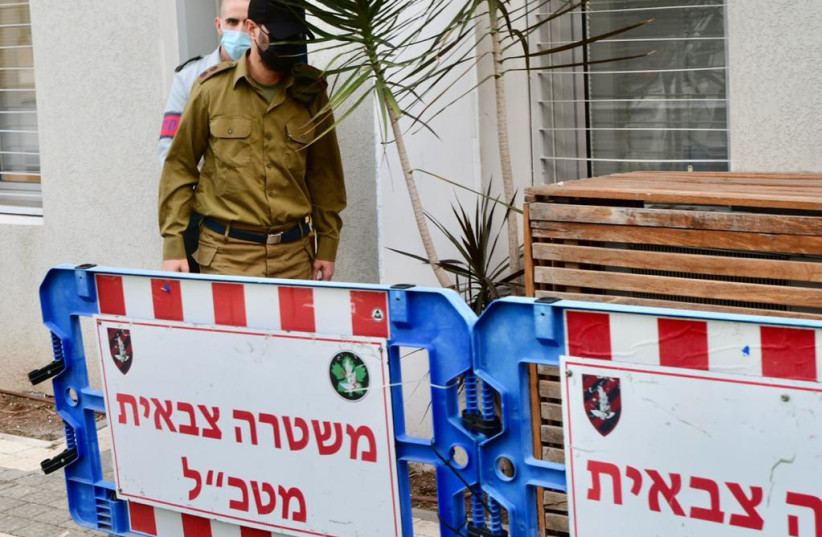   IDF officer Lt.-Col. Dan Sharoni is escorted out of the IDF military court in the Kirya military headquarters (credit: AVSHALOM SASSONI/MAARIV)