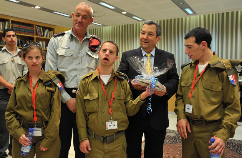Israel's Defence Minister Ehud Barak and the IDF Chief of Staff Benny Gantz give presents for the upcoming Jewish holiday of Passover, to disabled Israeli soldiers. April 13, 2011. (credit: MINISTRY OF DEFENCE/FLASH90)