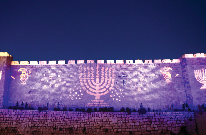  Images of Hanukkah are splashed on the walls of Jerusalem’s Old City. (photo credit: MARC ISRAEL SELLEM)