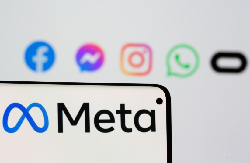  Facebook's new rebrand logo Meta is seen on smartpone in front of displayed logo of Facebook, Messenger, Intagram, Whatsapp and Oculus in this illustration picture taken October 28, 2021 (photo credit: DADO RUVIC/REUTERS ILLUSTRATION)