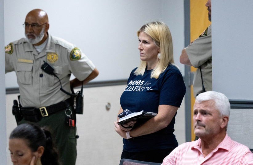  Robin Steenman, chair of the local chapter of Moms for Liberty, waits to speak at a board of education meeting, where she will make a public comment against teaching 