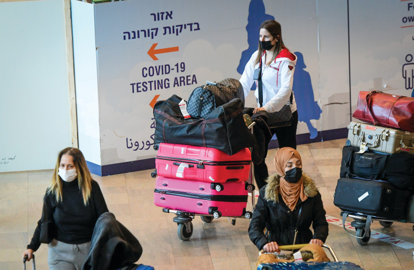  RETURNING ISRAELIS at Ben-Gurion Airport this week. Why were foreign travelers banned? (photo credit: AVSHALOM SASSONI/FLASH90)