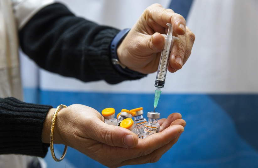  A photo illustration showing ampoules of Covid-19 vaccine for children at a Clallit vaccine center in Jerusalem on November 28, 2021. (credit: OLIVIER FITOUSSI/FLASH90)