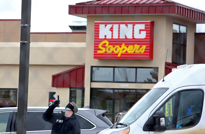 An FBI agent surveys the site of a mass shooting at a King Soopers grocery store in Boulder, Colorado, US, March 23, 2021. (credit: REUTERS/KEVIN MOHATT)