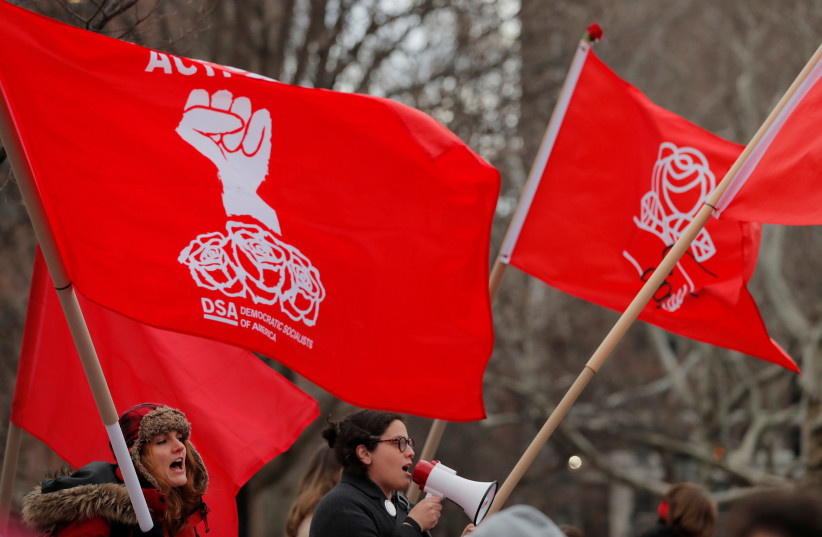 Demonstrators with the Democratic Socialists of America take part in a rally on International Women’s Day in Manhattan in New York City, New York, US, March 8, 2018. (credit: REUTERS/LUCAS JACKSON)