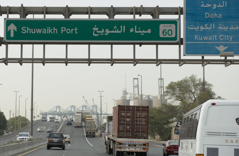  Freight trucks and vehicles drive on the only entrance to Kuwait's Shuwaikh Port from the Ghazalli Bridge in Shuwaikh February 11, 2013 (photo credit: REUTERS/STEPHANIE MCGEHEE)