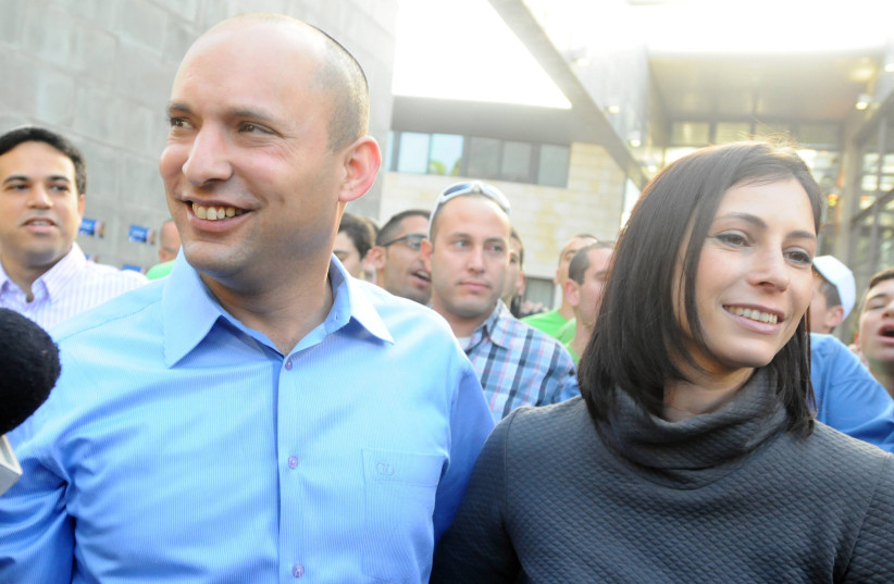  Naftali Bennett, leader of the Bayit Yehudi party and his wife Gilat make their way to the ballot box to cast a vote in the Israeli general elections on Tuesday, January 22, 2012 Raanana (photo credit: YOSSI ZELIGER/FLASH90)