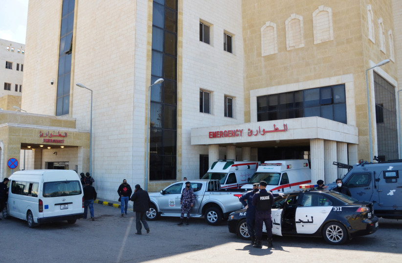  Police officers stand outside the new Salt government hospital in the city of Salt, Jordan March 13, 2021 (photo credit: REUTERS/MUATH FREIJ)