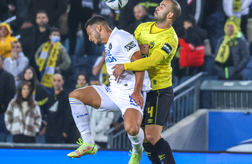  MACCABI TEL AVIV (in white) and Beitar Jerusalem dueled on Sunday night in the capital, with the visitors claiming a 2-1 victory after an exciting contest (photo credit: DANNY MARON)