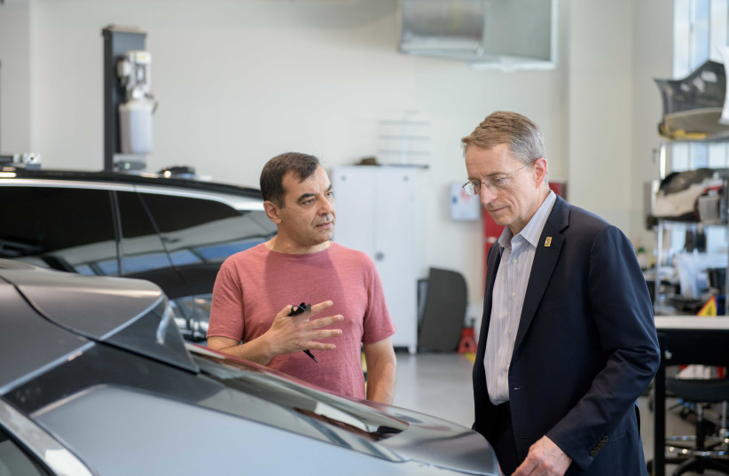 Intel CEO Pat Gelsinger and Mobileye CEO Amnon Shashua examine one of the company's autonomous cars. (credit: COURTESY MOBILEYE)