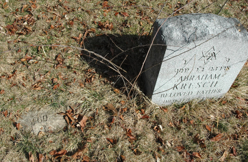  A number marks a Jewish grave, left, at the former Central Islip Psychiatric Center on New York's Long Island. A stone at right was added after the hospital began working with a Jewish burial society.  (photo credit: Patricia Desrochers/Touro Law Center)