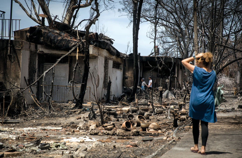  Residents check what is left of their homes after the forest fire, in Mevo Modi'im, May 2019 (photo credit: HADAS PARUSH/FLASH90)
