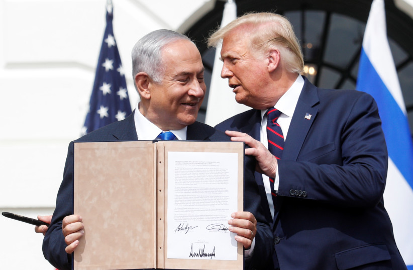  Israel's Prime Minister Benjamin Netanyahu stands with US President Donald Trump after signing the Abraham Accords, normalizing relations between Israel and some of its Middle East neighbors, in a strategic realignment of Middle Eastern countries against Iran, on the South Lawn of the White House i (credit: REUTERS/TOM BRENNER)