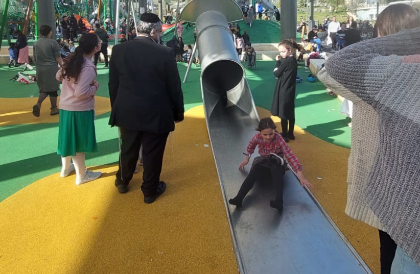  A girl comes out from one of the tower's long slides. (credit: NATAN ROTHSTEIN)