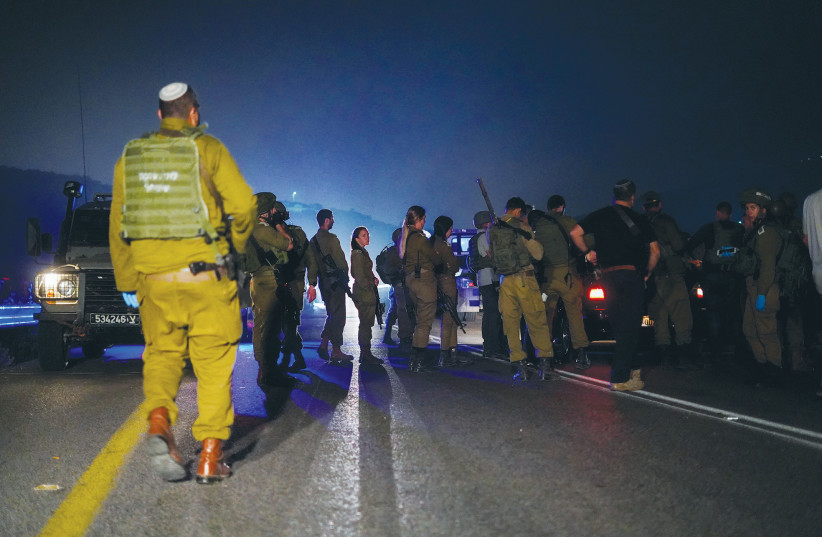  SECURITY FORCES inspect the scene of a shooting attack in Samaria earlier this year. (photo credit: HILLEL MAEIR/FLASH90)