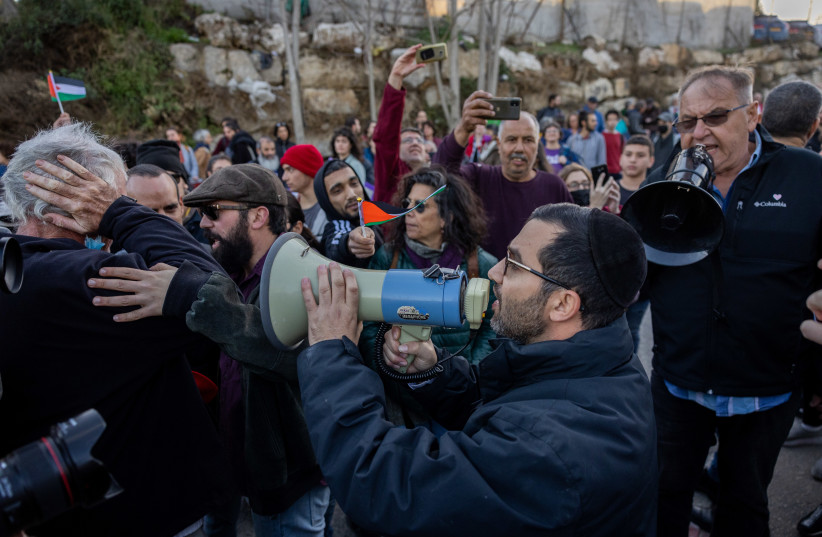  Left Wing Activist argue with Right Wing Activists during a protest against evacuation of Palestinian families from their home in the east Jerusalem neighborhood of Sheikh Jarrah, December 10, 2021. (credit: YONATAN SINDEL/FLASH90)