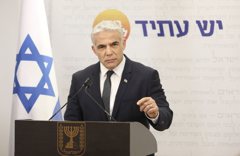  Foreign Minister and Yesh Atid head Yair Lapid at his faction's meeting, December 13, 2021. (photo credit: MARC ISRAEL SELLEM/THE JERUSALEM POST)