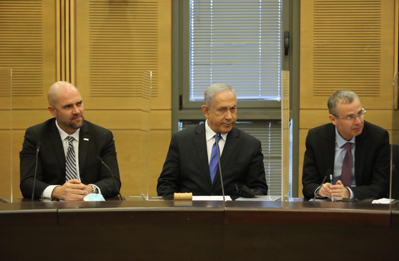  Likud MKs Amir Ohana, opposition head Benjamin Netanyahu and Yariv Levin at the Likud faction meeting, December 13, 2021. (photo credit: MARC ISRAEL SELLEM/THE JERUSALEM POST)