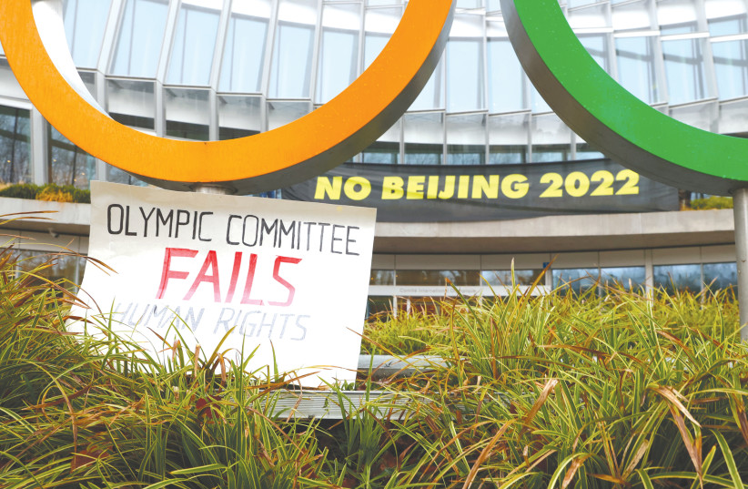 SIGNS IN PROTEST against holding the Olympic Games in Beijing are displayed outside the headquarters of the International Olympic Committee in Lausanne, Switzerland. (credit: DENIS BALIBOUSE/REUTERS)