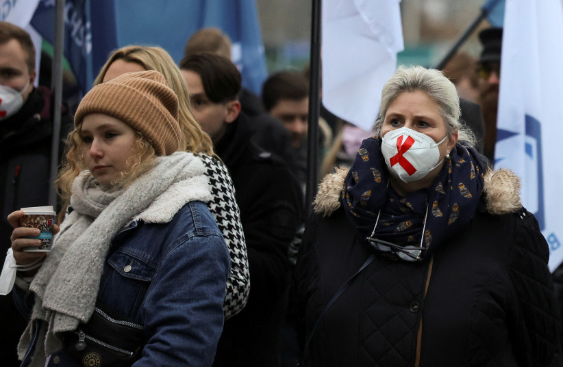  Demonstrators attend a protest against government measures to curb the spread of the coronavirus disease (COVID-19) in Berlin, Germany, December 11, 2021 (credit: REUTERS)