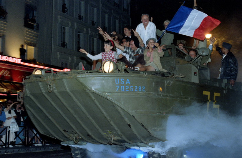  People aboard an American landcraft vehicle reenact the August 1944 liberation of Paris, the city where much of the storyline of ‘Julius Matthias: Hope Reborn’ is set.  (credit: REUTERS)