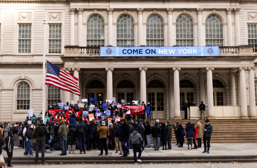 People take part in a rally 'Victory Rally' to allow non-citizen NYC residents to vote in local elections, at the steeps of the New York City Hall, in New York, US, December 9, 2021. (credit: REUTERS/EDUARDO MUNOZ)