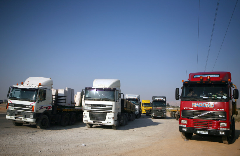 Trucks wait at the King Hussein border crossing (Allenby Bridge) to cross to Jordan, July 21. (credit: MATANYA TAUSIG/FLASH90)
