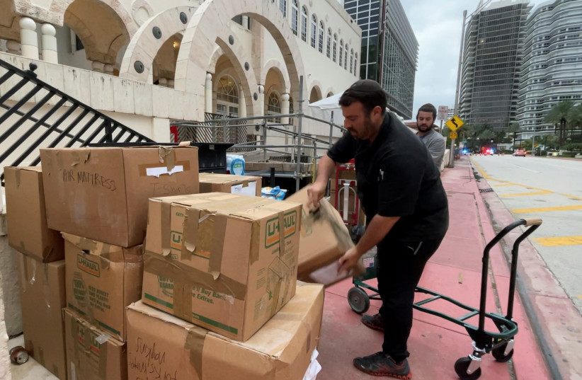  VOLUNTEERS ORGANIZE donated goods for delivery to families of building collapse victims in Surfside, Florida, in June. The author believes in the power of such positive religious action even when negative things happen.  (photo credit: REUTERS/KATANGA JOHNSON)
