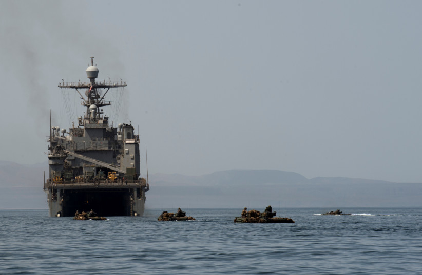  Amphibious Assault Vehicles cruise towards the well deck of the amphibious dock landing ship USS Harpers Ferry (LSD 49), in Gulf of Aden (photo credit: KEYPHER STROMBECK/US NAVY/HANDOUT)