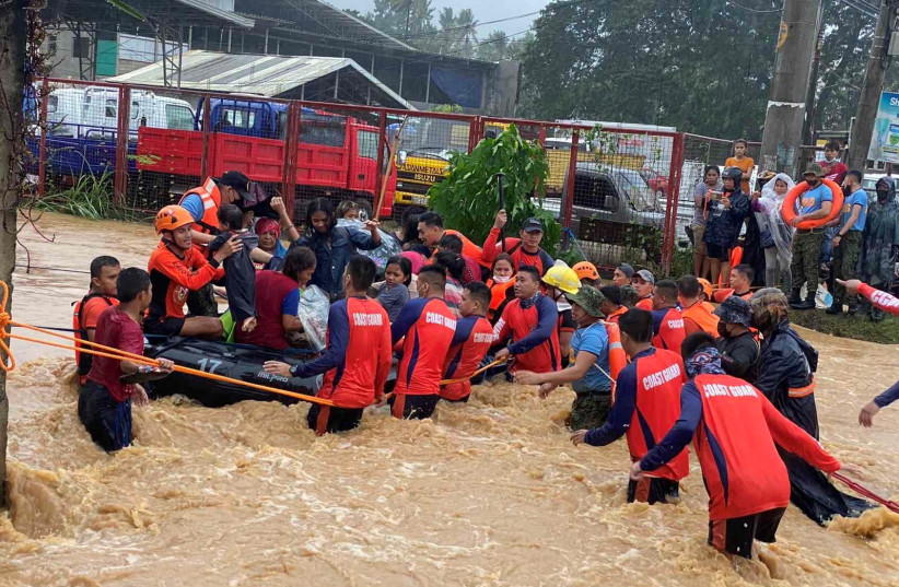  Philippine Coast Guard personnel rescue residents after being inundated by floods caused by Typhoon Rai in Cagayan De Oro City, Philippines, December 16, 2021. (photo credit: PHILIPPINE COAST GUARD/HANDOUT VIA REUTERS)