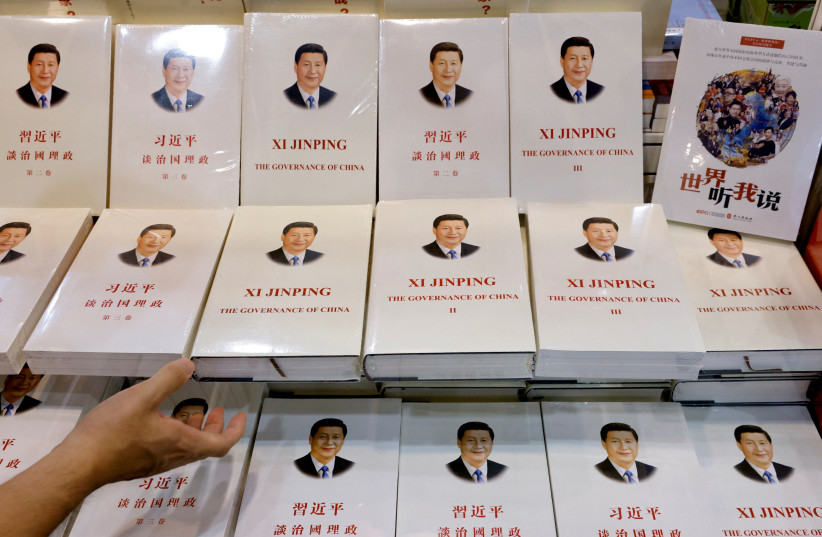 Copies of the book 'Xi Jinping: The Governance of China' are displayed at the Hong Kong Book Fair, in Hong Kong, China, July 14, 2021. (credit: REUTERS/TYRONE SIU/FILE PHOTO)