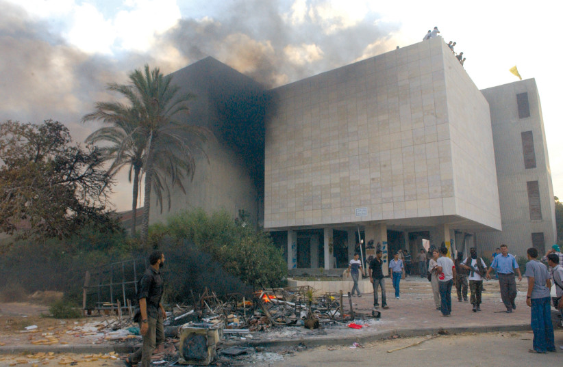 Palestinians set fire to a yeshiva building in the former Israeli community of Neve Dekalim after the Israeli disengagement from the Gaza Strip in 2005. (photo credit: YOSSI ZAMIR/FLASH90)