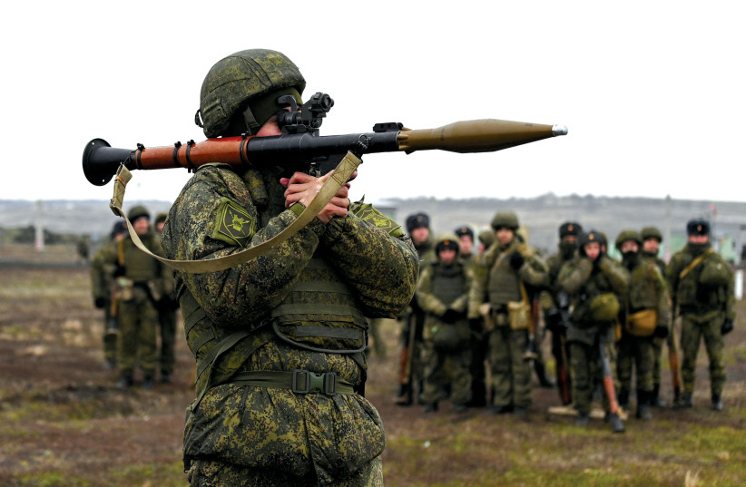 A grenade launcher operator of the Russian armed forces takes part in combat drills last week in the Rostov region of Russia near Ukraine. (photo credit: SERGEY PIVOVAROV/REUTERS)